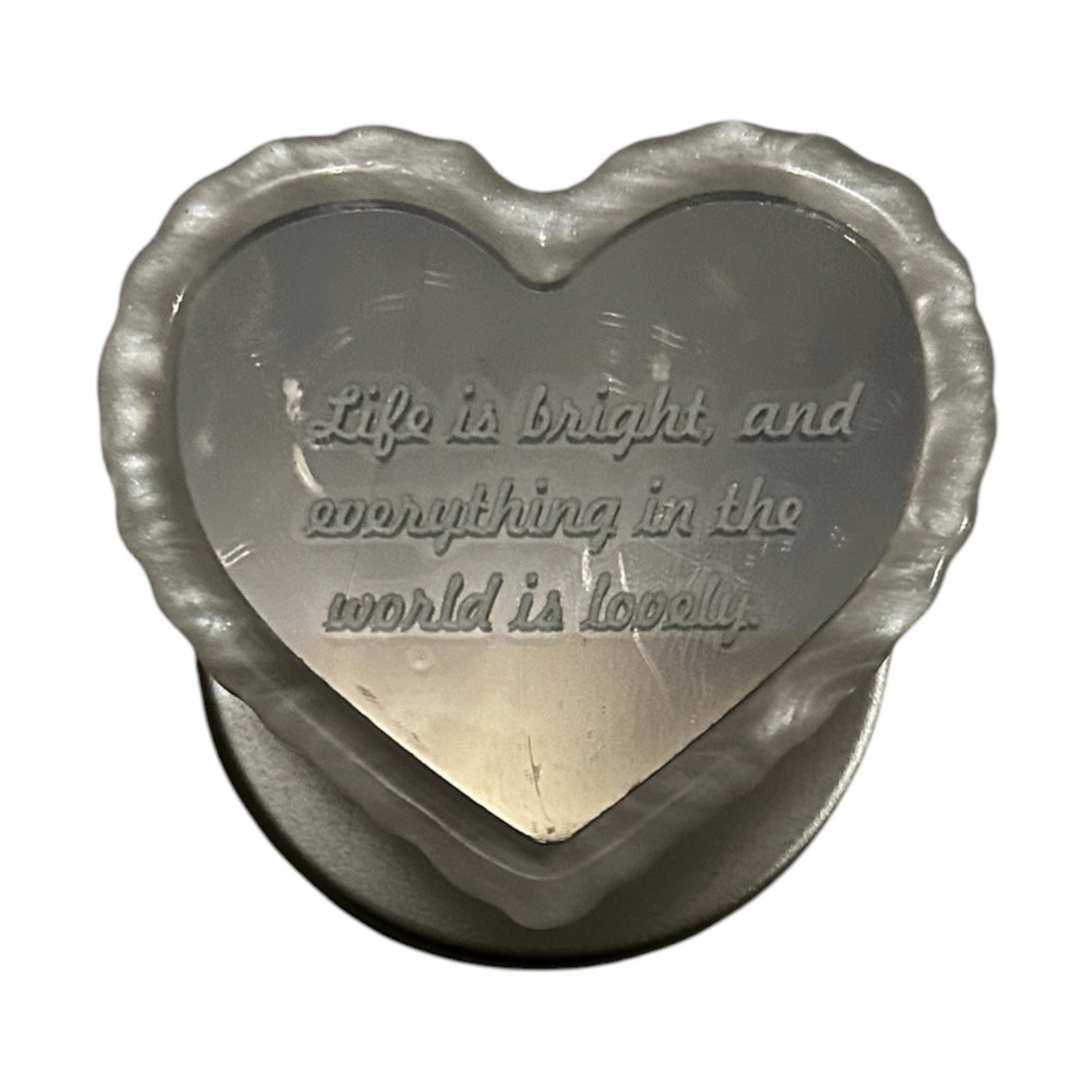 Cavalla Goods heart-shaped phone grip with a reflective mirror finish and engraved inspirational quote
